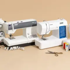 A sewing professional's dream: four white sewing machines from Husqvarna, Pfaff, Brother, and Singer, with spools of thread, fabric, and scissors.