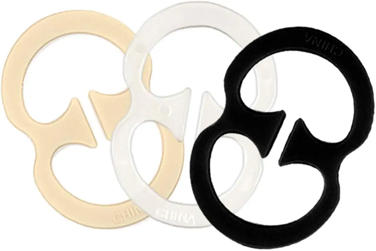Three bra strap clips in beige, clear, and black.